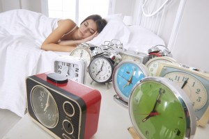 Woman Sleeping Beside Alarm Clocks